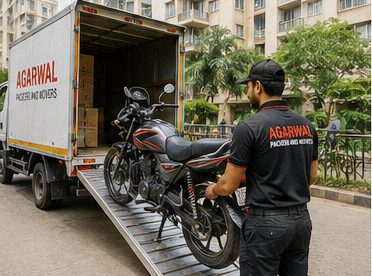 Bike being loaded onto an Agarwal Packers and Movers truck ramp
