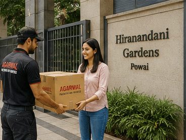 Agarwal Packers and Movers staff delivering a box at a Mumbai residence