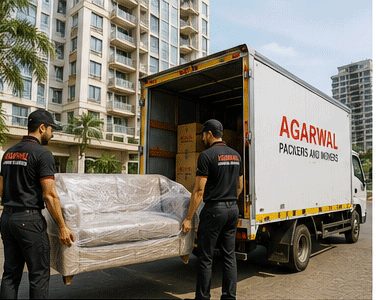 Loading a wrapped sofa into an Agarwal Packers and Movers truck
