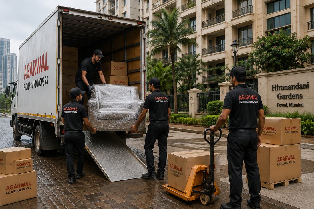 Agarwal Packers and Movers staff loading a wrapped sofa onto a truck ramp using a pallet jack